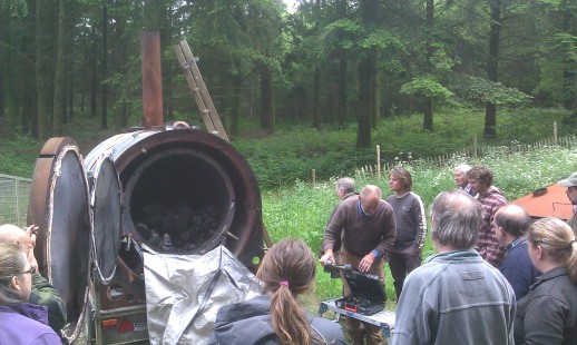 Alan Waters demonstrates his 'Exeter' retort charcoal kiln.